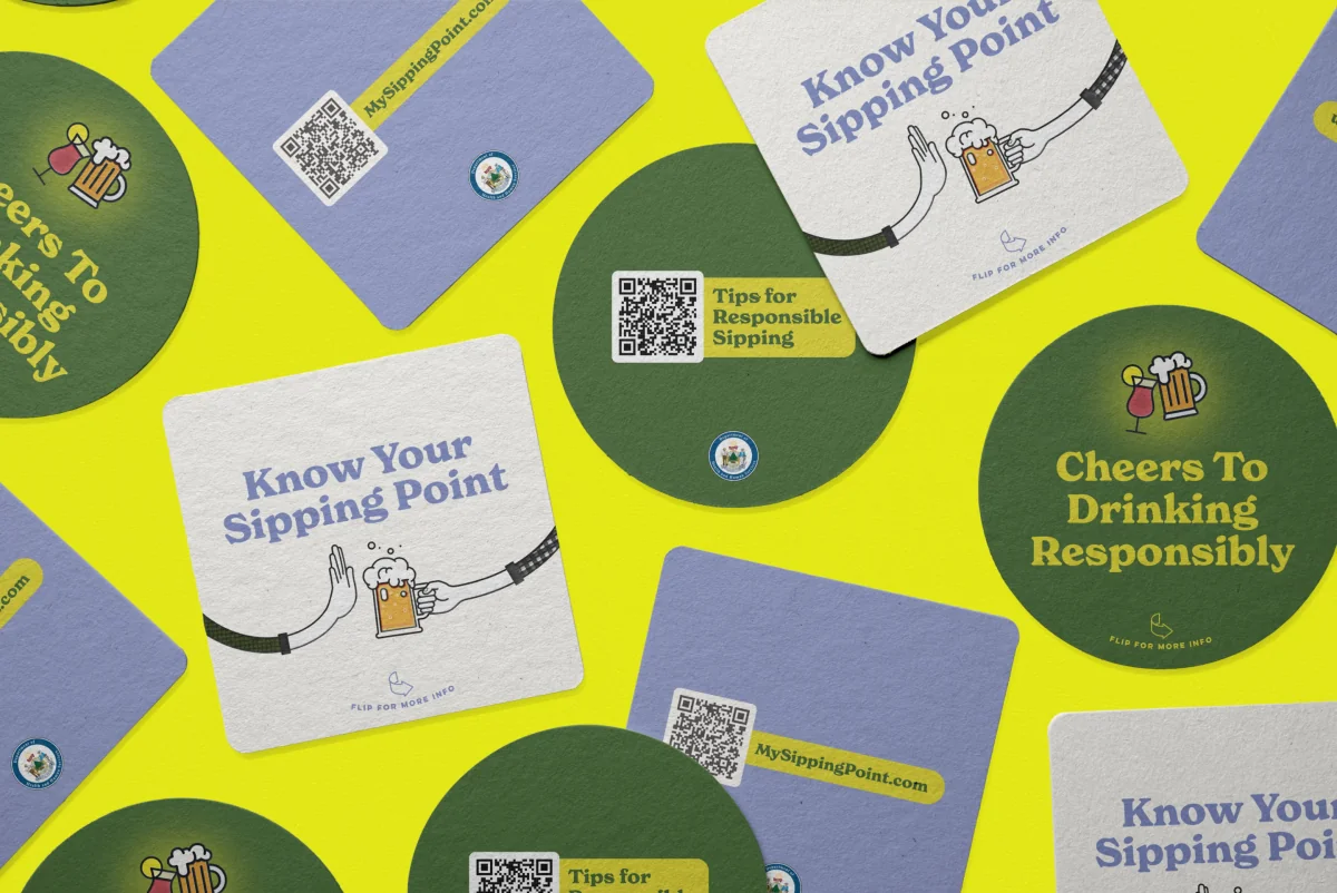 Promotional coasters featuring The Sipping Point campaign branding